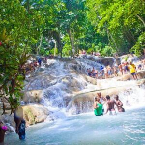 VibraGem Tours Dunn’s River Falls Tour in Jamaica with a group of people walking a human chain.