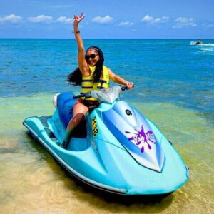 VibraGem Tours Jet Ski Tour in Jamaica with female tourist on blue Jet Ski