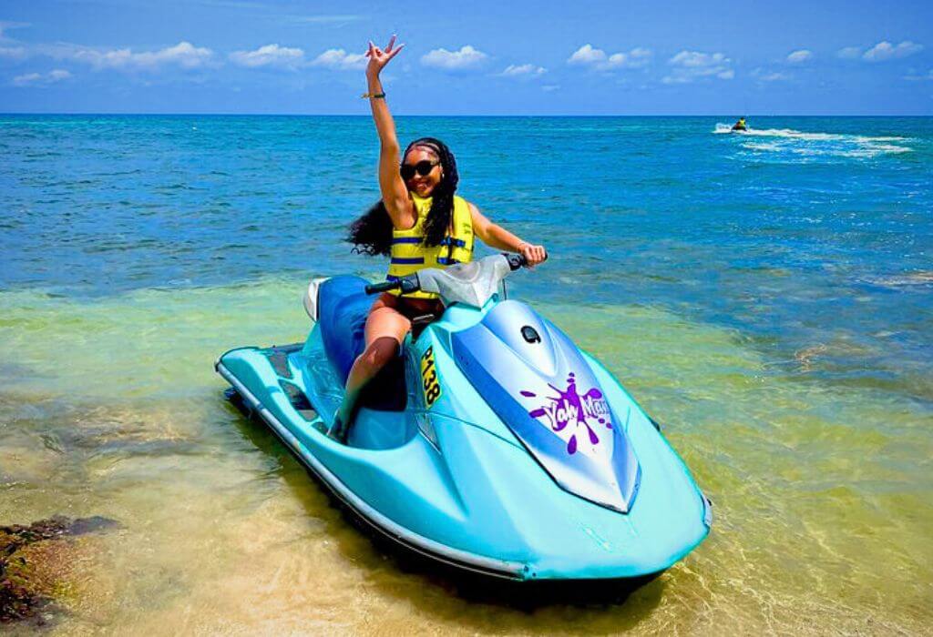 VibraGem Tours Jet Ski Tour in Jamaica with female tourist on blue Jet Ski