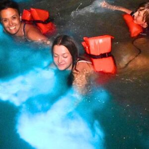 VibraGem Tours Luminous Lagoon Glistening Waters Tour in Jamaica with three people swimming in glistening water.