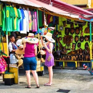 VibraGem Tours Montego Bay City Tour in Jamaica with two tourist females shopping at montego bay crafts market.